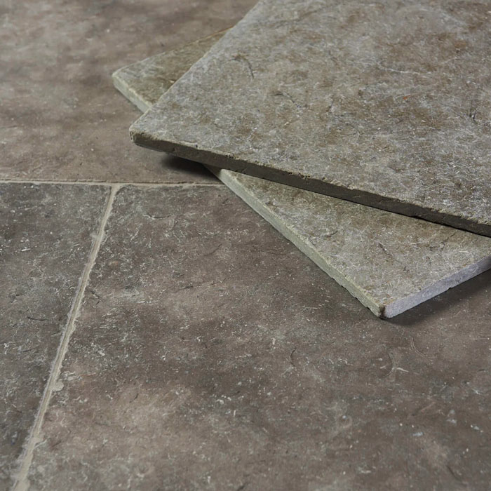 Close-up of grey Milan tumbled limestone floor tiles